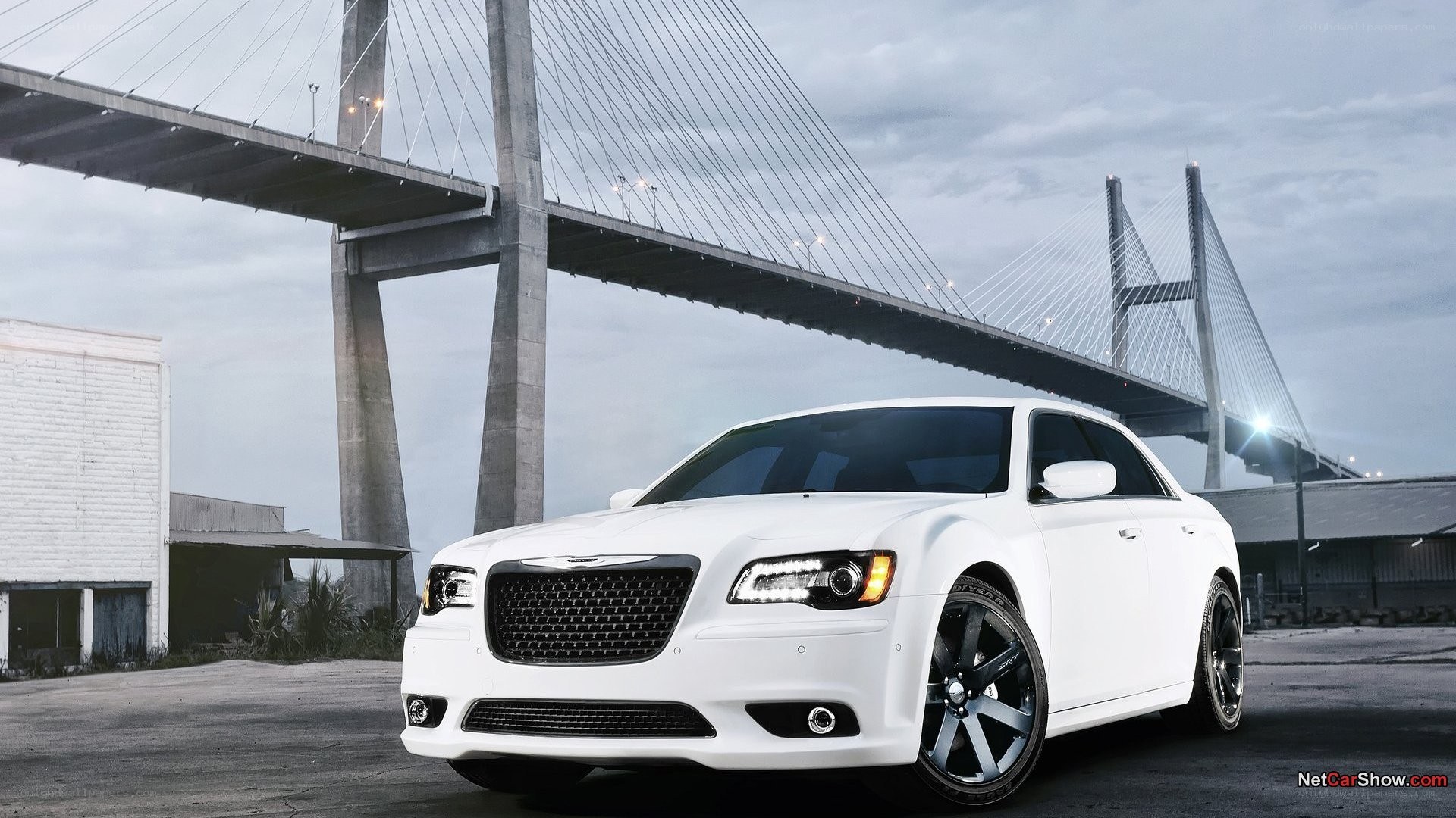 White Chrysler 300 by a bridge