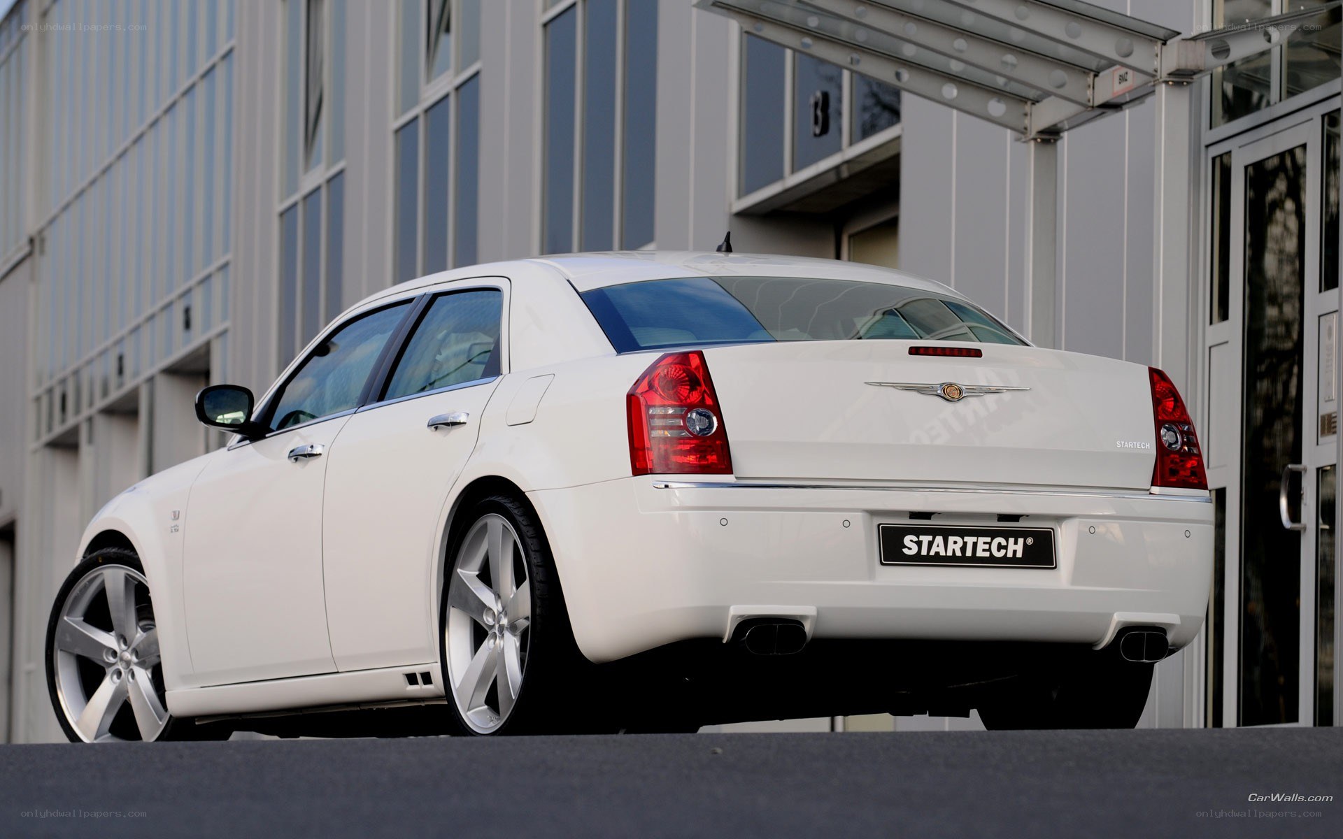 white chrysler sedan with startech badge