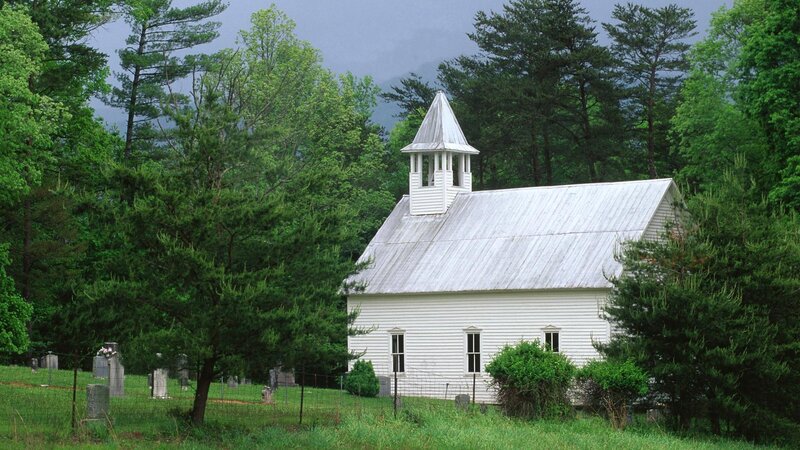 White church in forested area