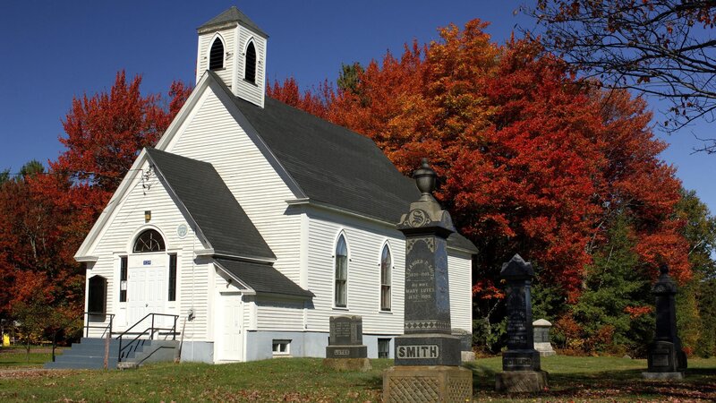 white church with autumn trees