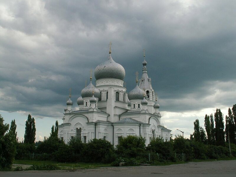 White church with domes under cloudy sky