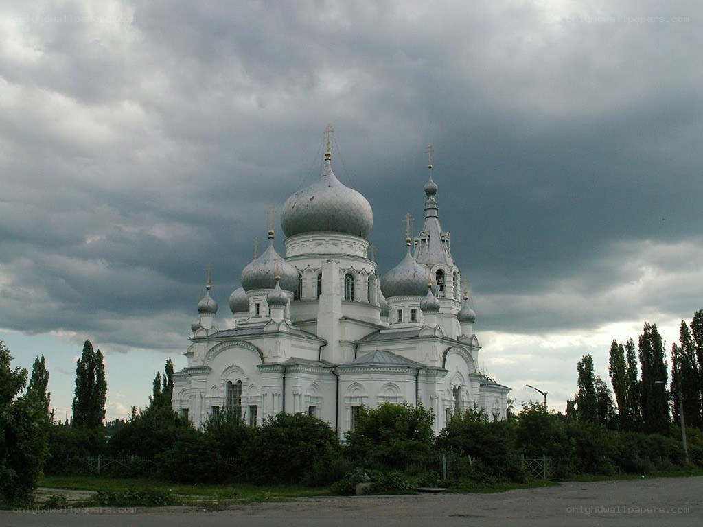 White church with domes under cloudy sky