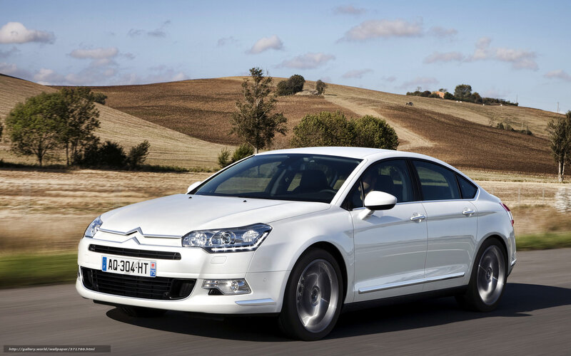 White Citroen C5 driving on country road