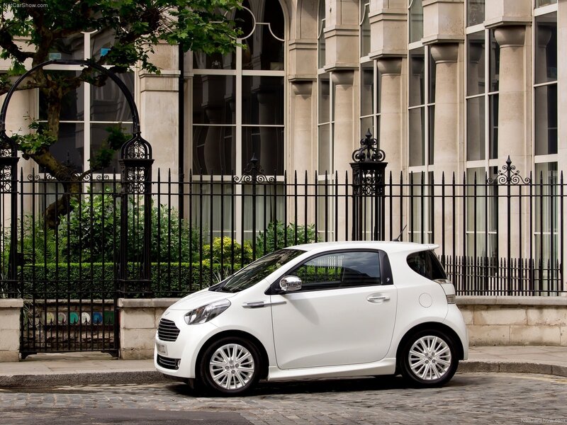 White city car on cobblestone street