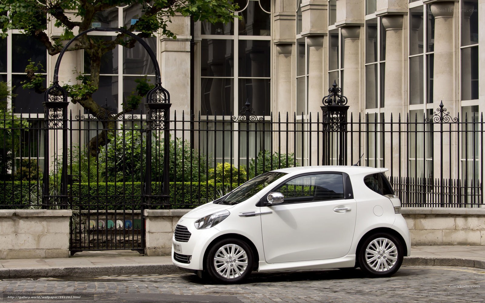 White city car on cobblestone street