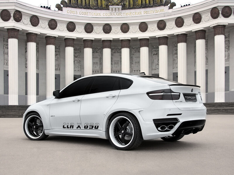 White CLA X650 car in front of monument