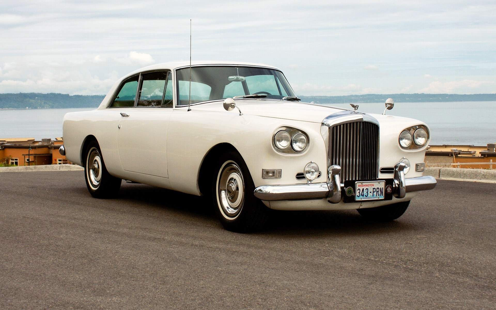 white classic car by the water