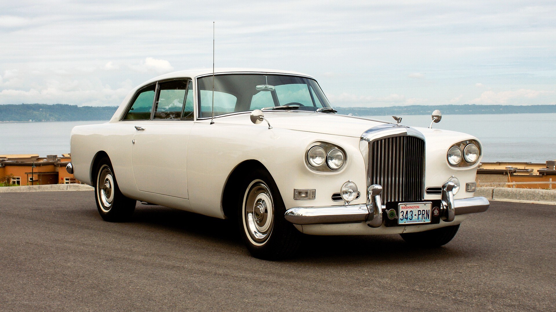 white classic car by water