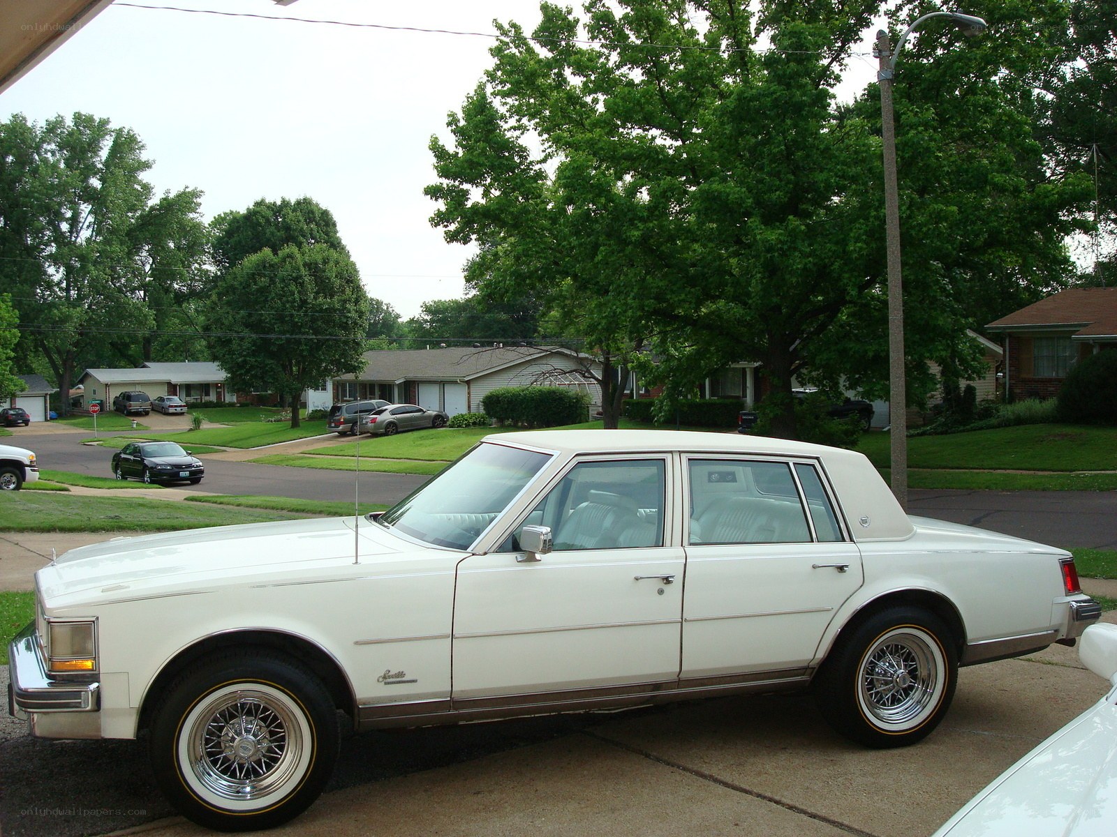 white classic car in driveway