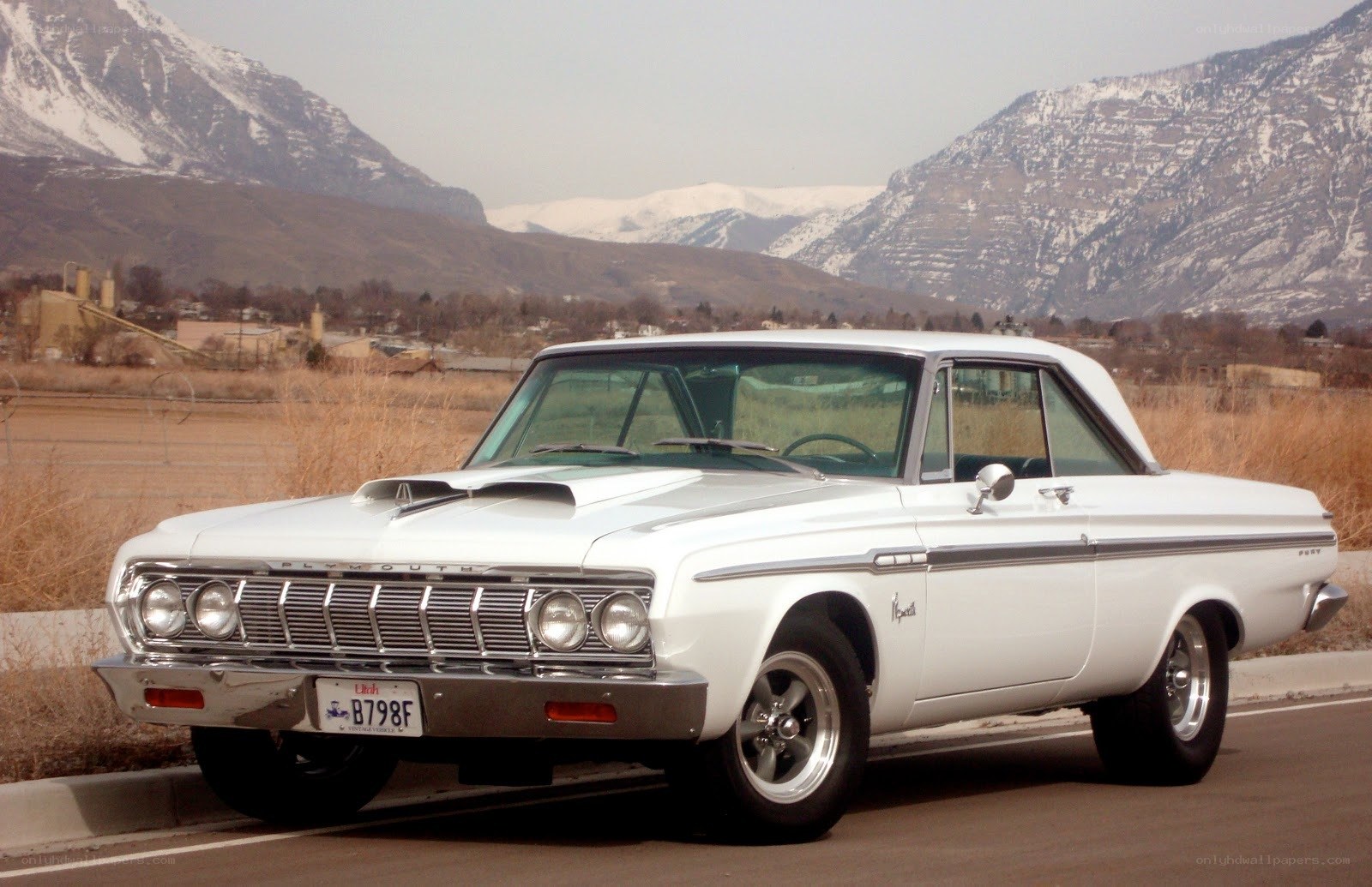 White classic car in mountain setting