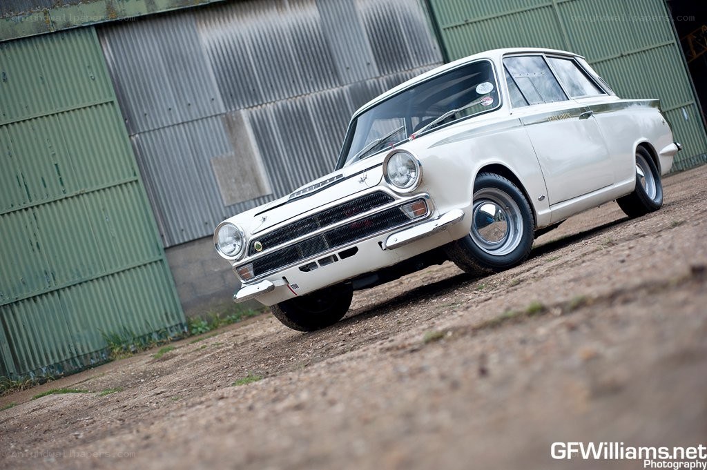white classic car on dirt