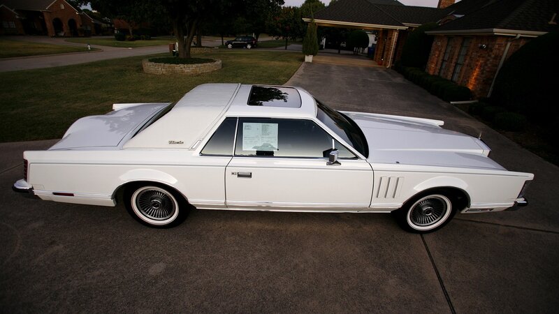 white classic car on driveway