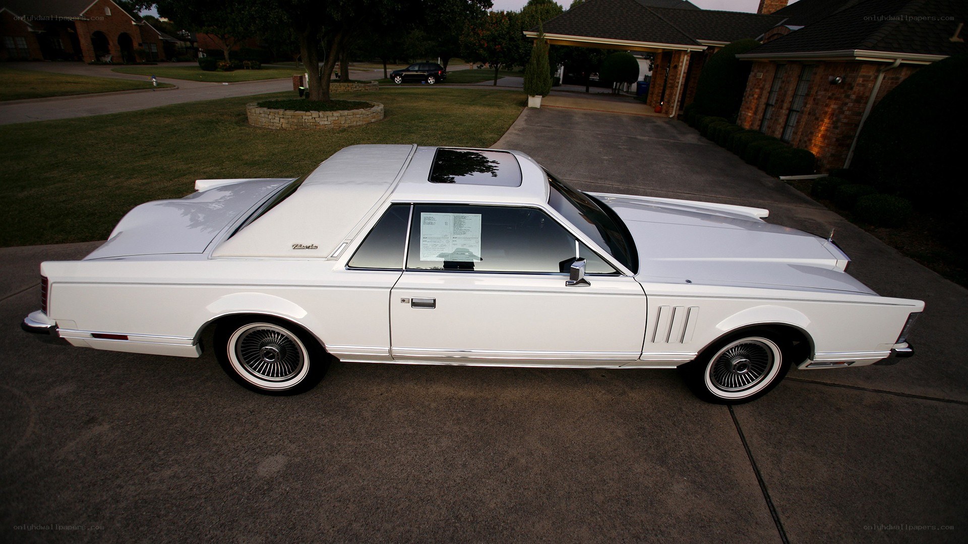white classic car on driveway
