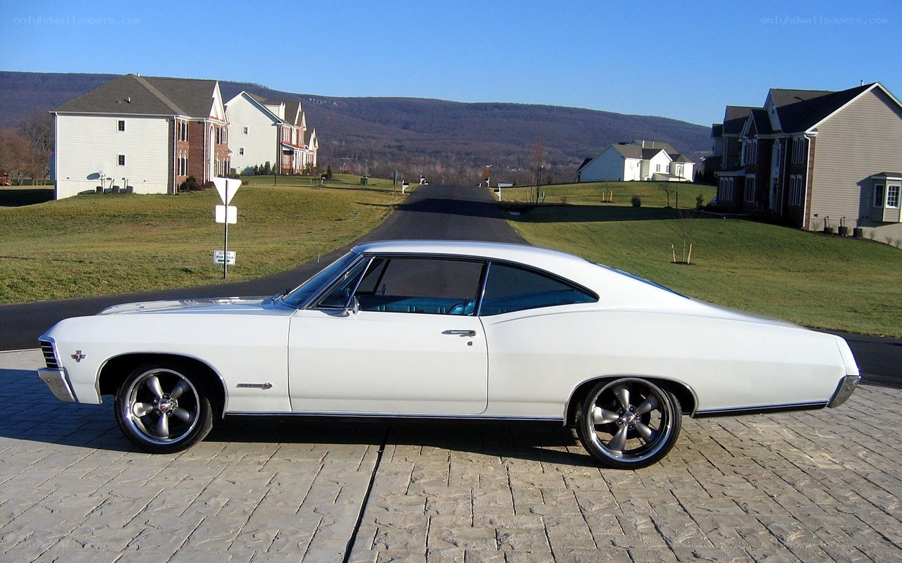 White classic car on driveway
