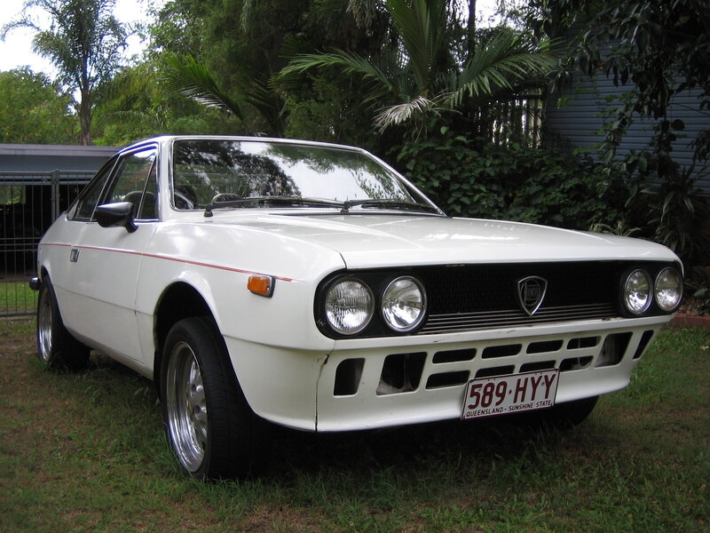 white classic car on grass