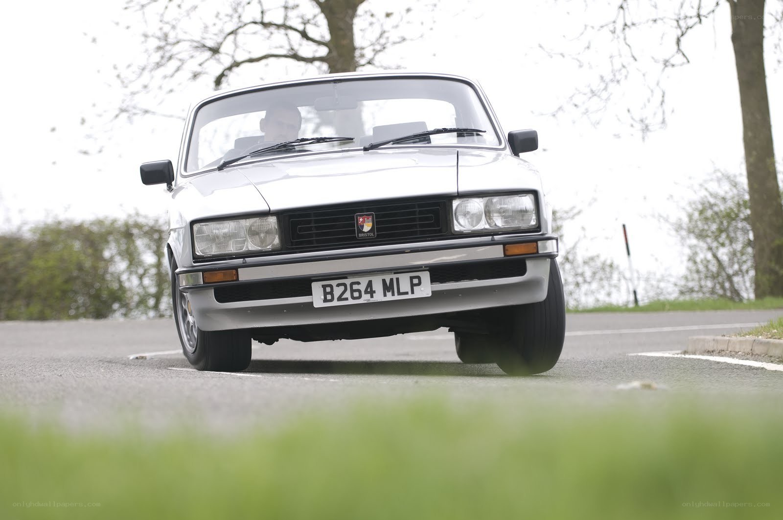 white classic car on road