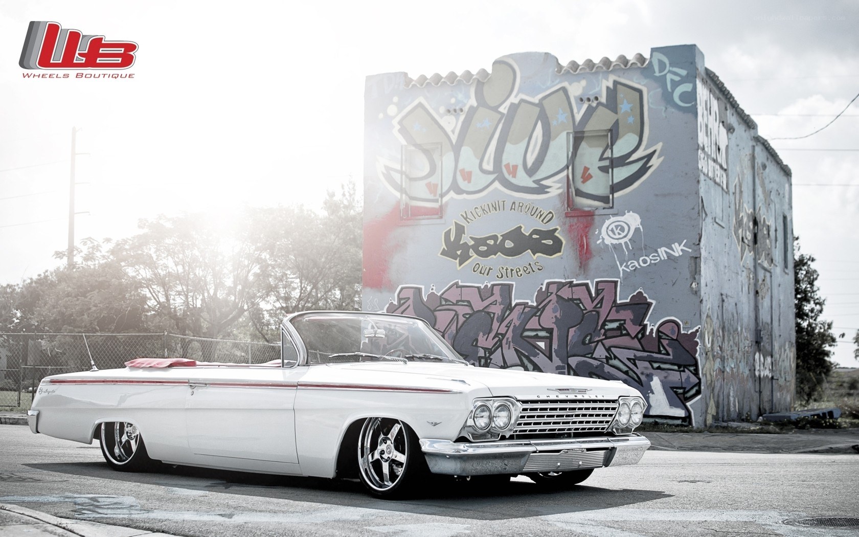 White classic car with graffiti