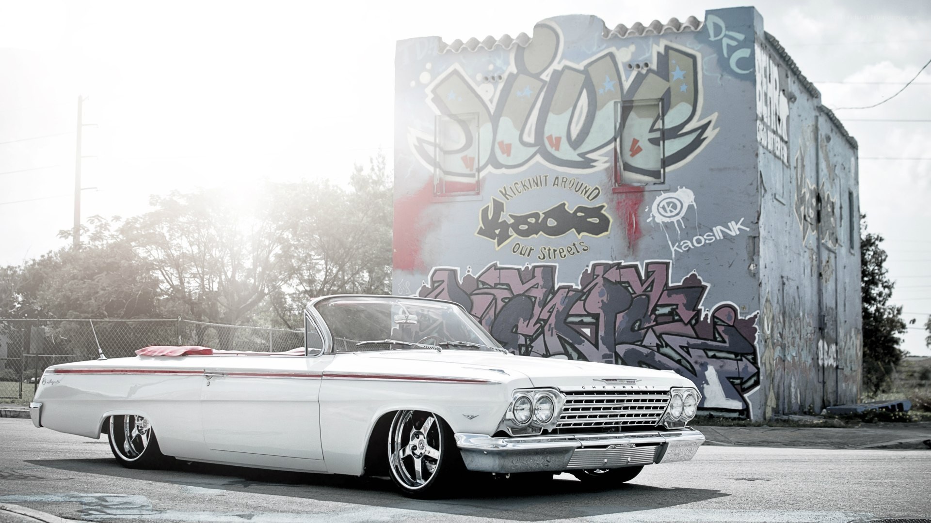 White classic car with graffiti