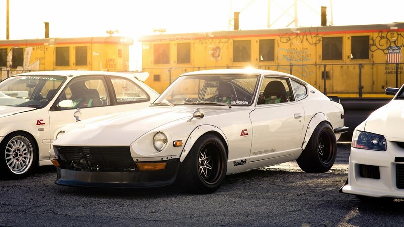 white classic cars at sunset