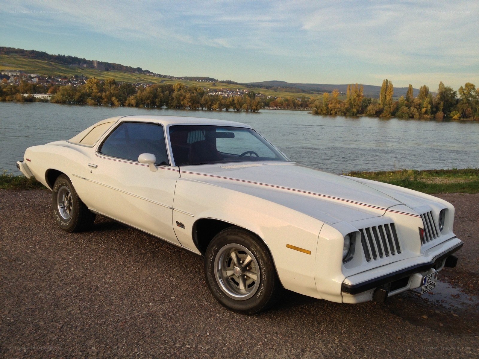 White classic muscle car by the river