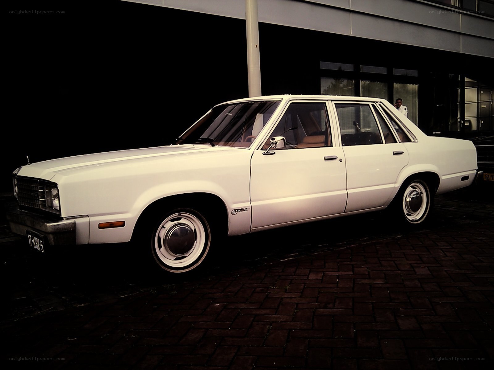 White classic sedan parked outside