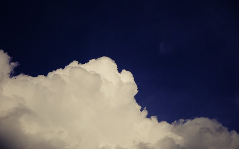 white cloud against dark sky
