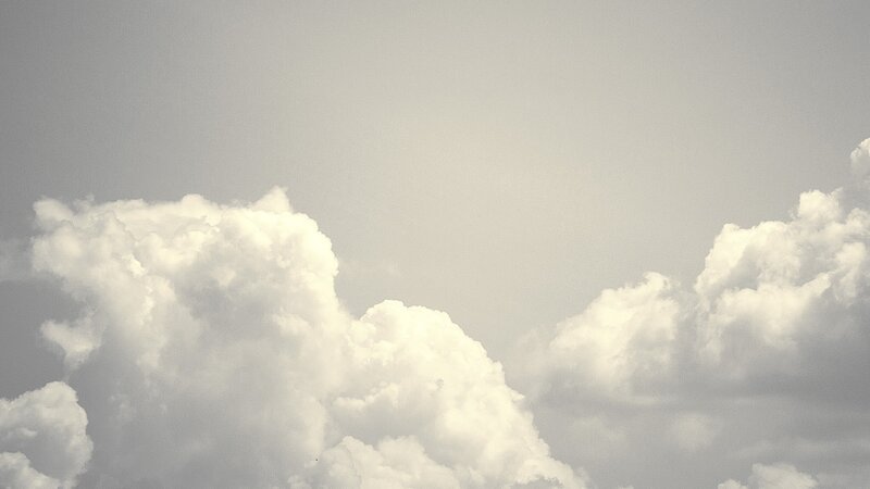 white clouds in gray sky