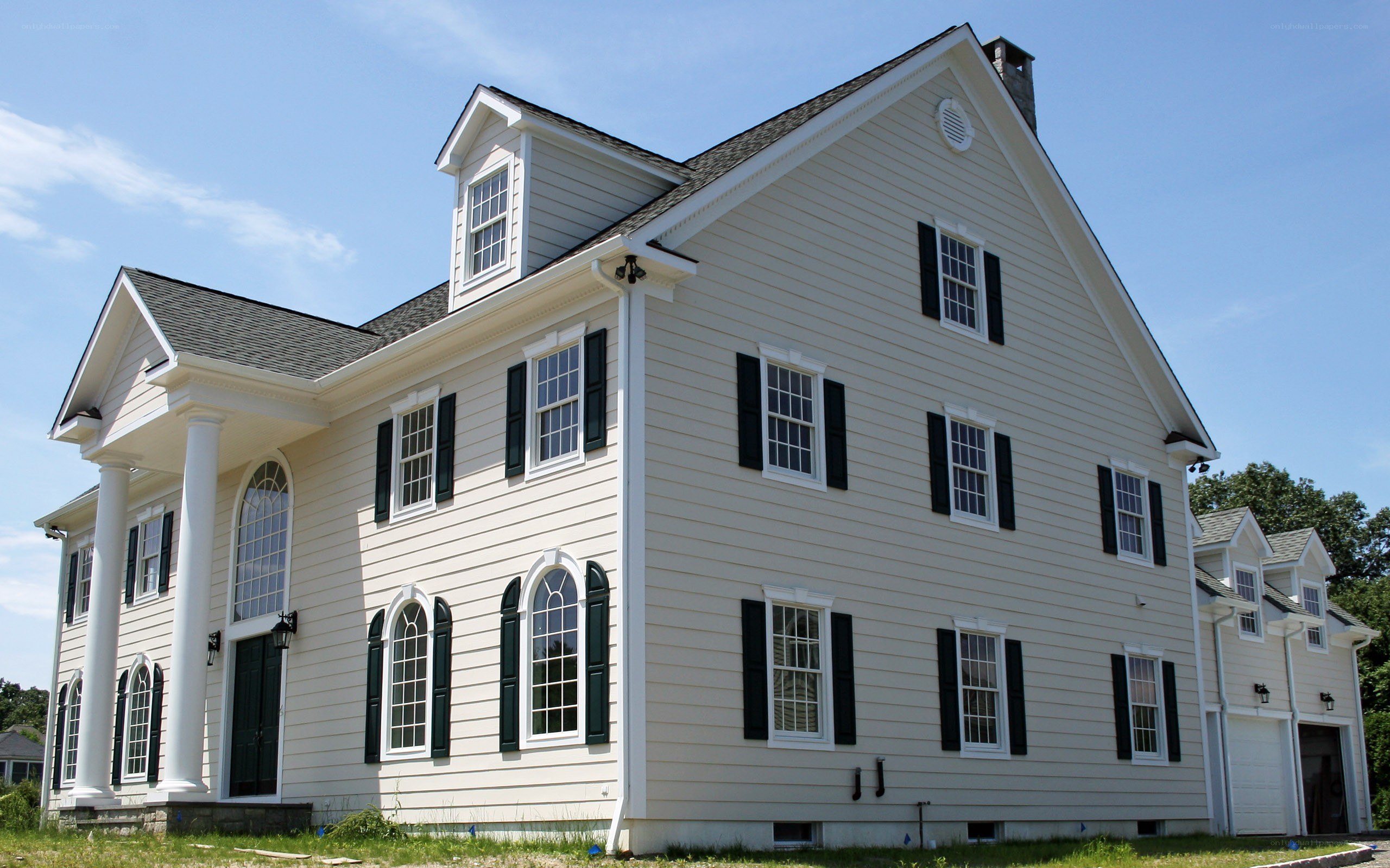 white colonial house with black shutters