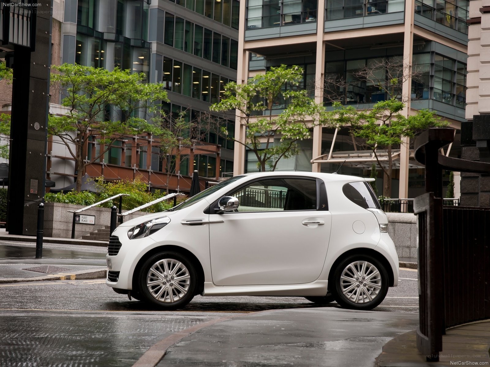 White compact car on city street