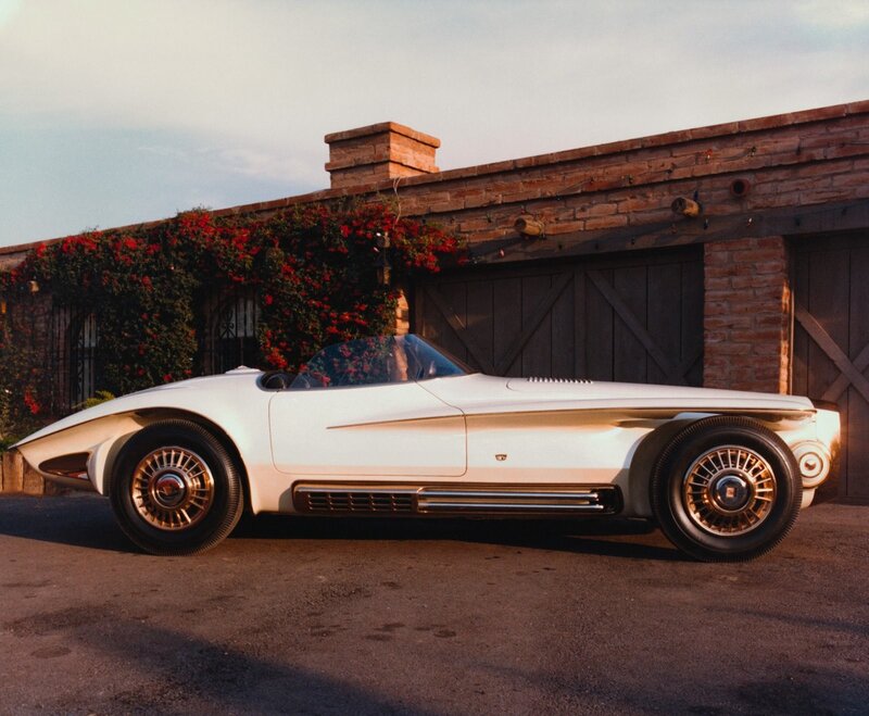 White concept car in front of garage