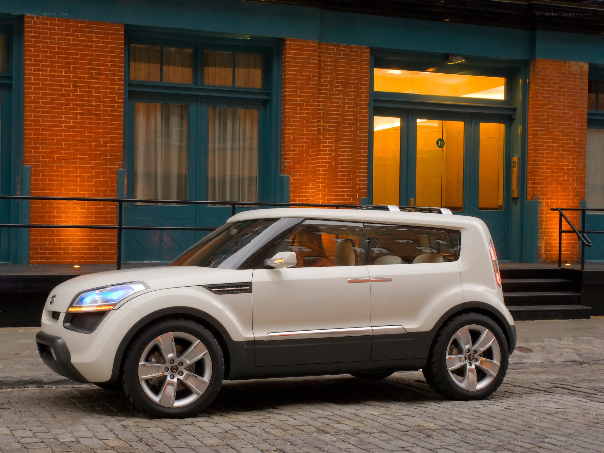 White concept car on cobblestone street