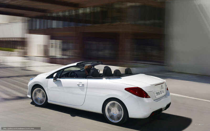 White convertible driving on city street