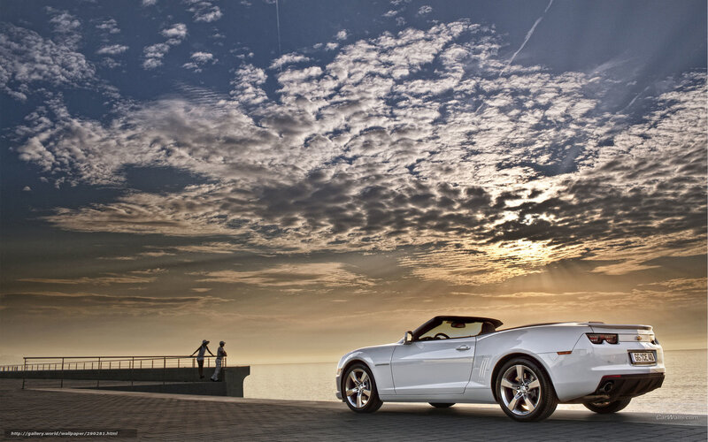 White convertible on a pier at sunset