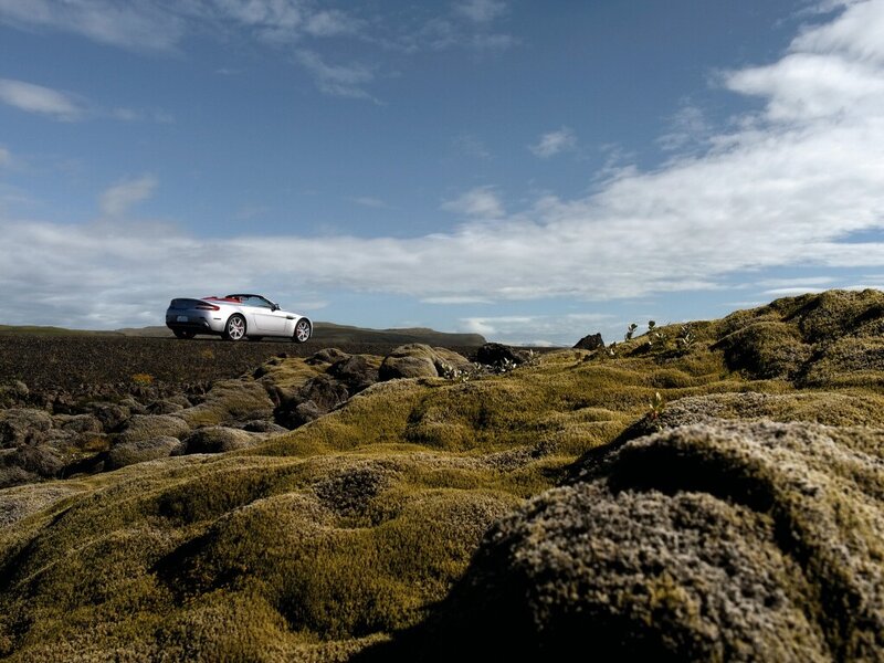 White convertible on mossy landscape