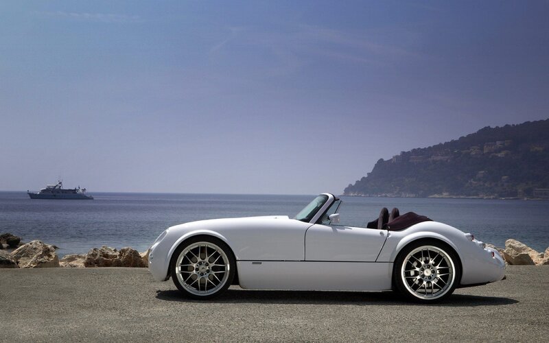 White convertible sports car by the sea