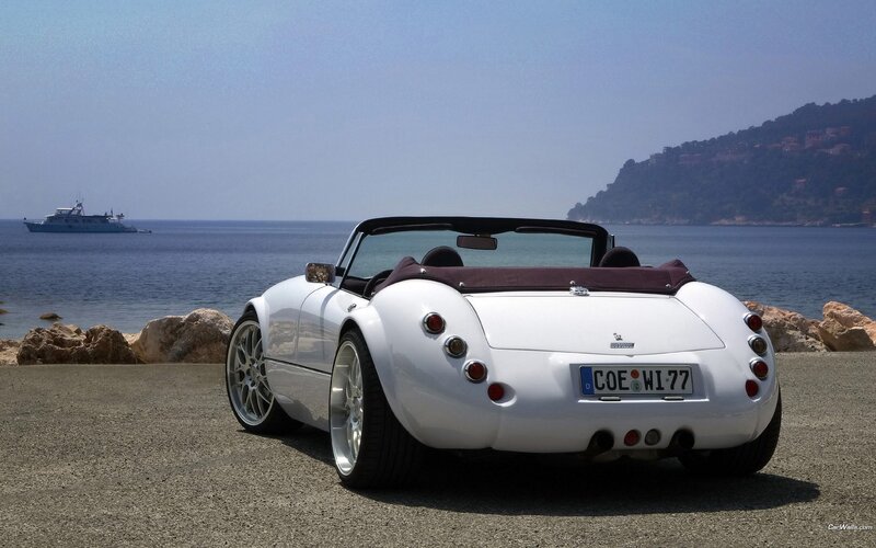 White convertible sports car by the sea