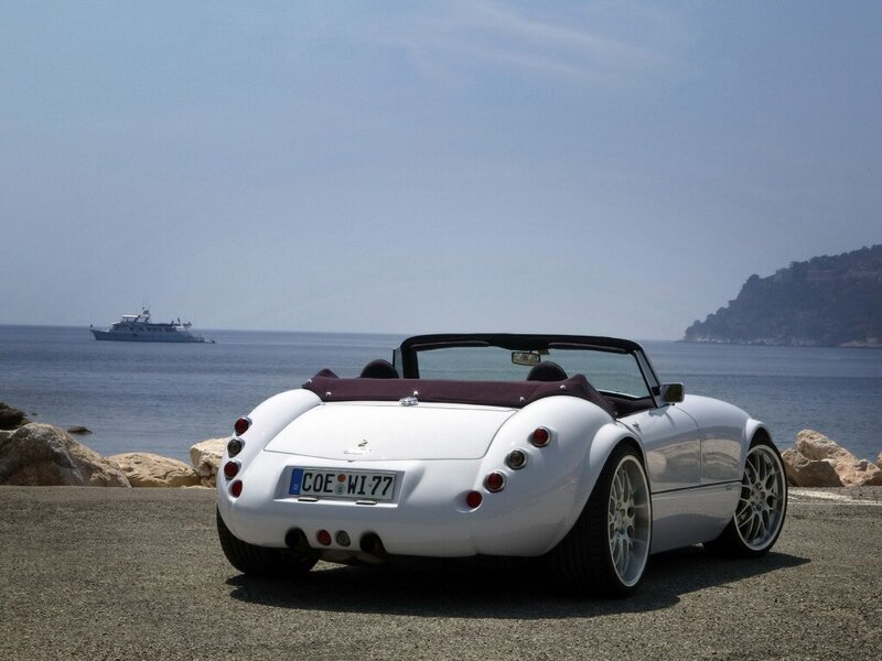 White convertible sports car by the sea