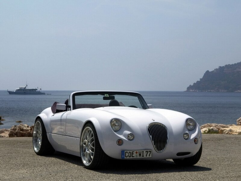 White convertible sports car by the sea