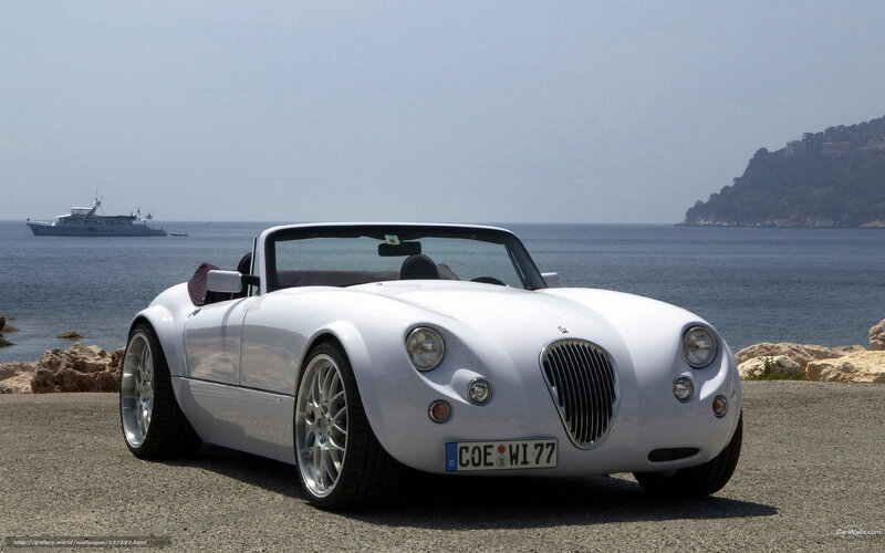 White convertible sports car by the sea