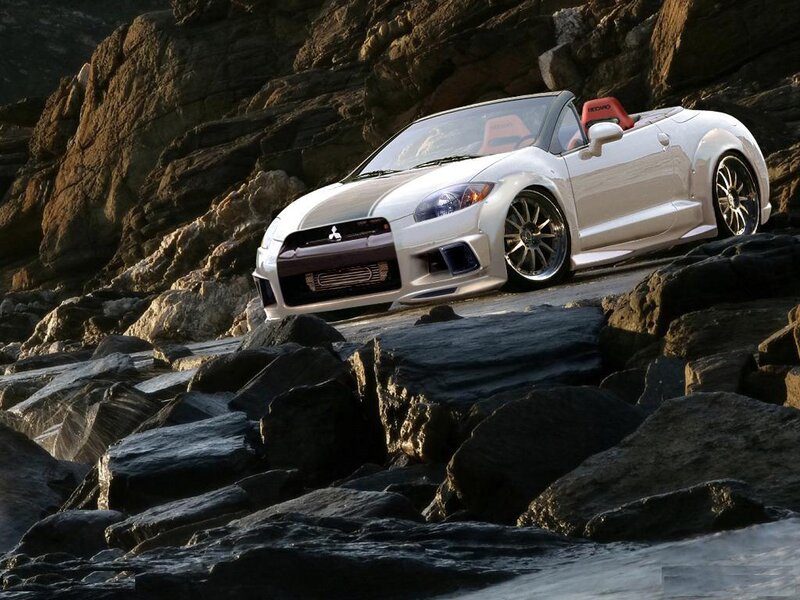 White convertible sports car on rocks