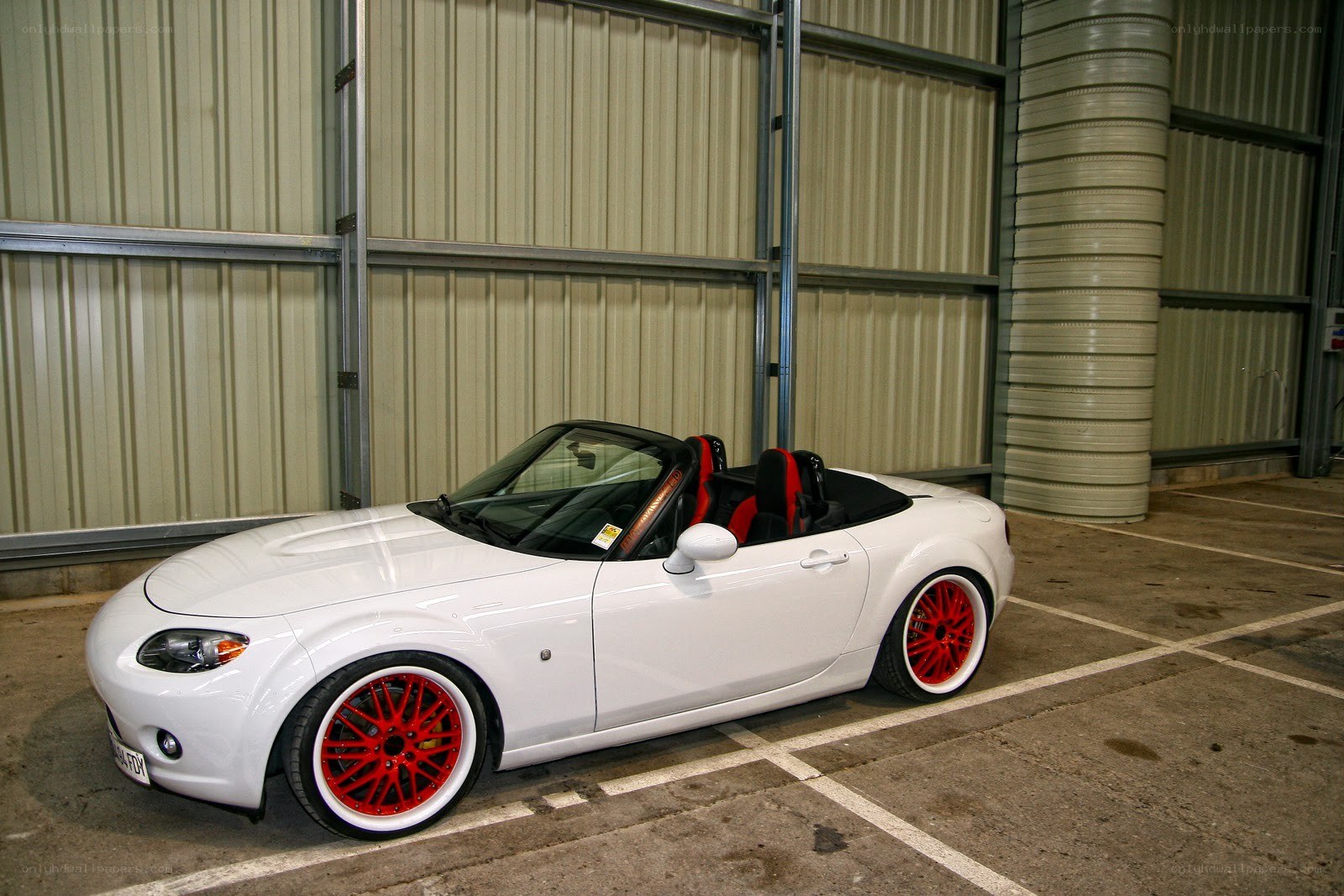 White convertible with red wheels