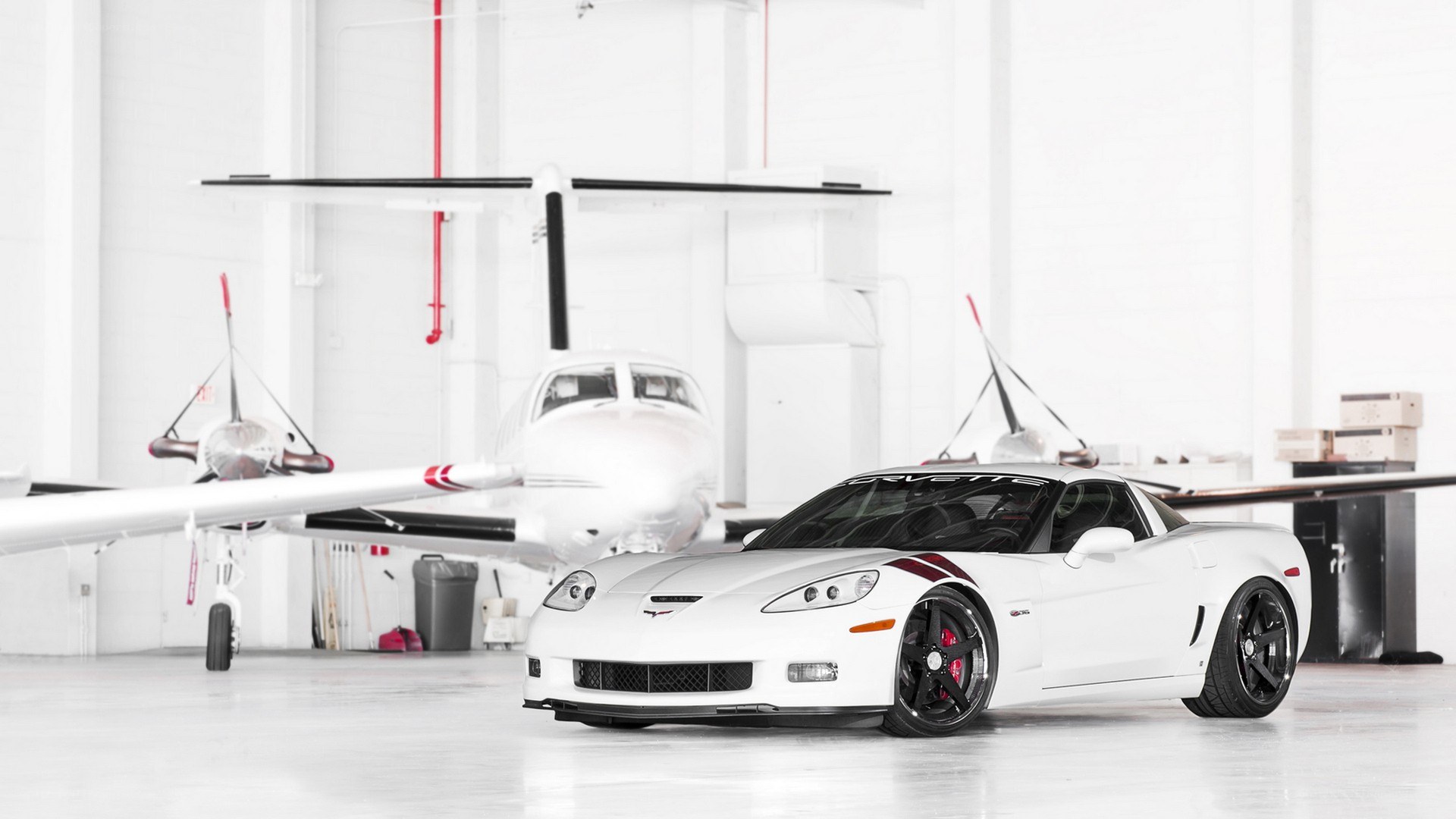 White Corvette in a hangar