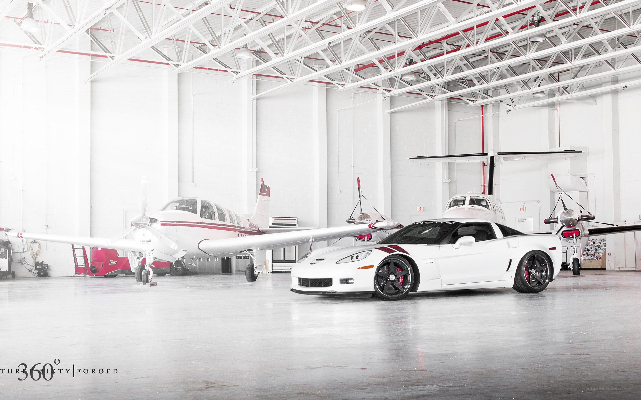 White Corvette in a hangar