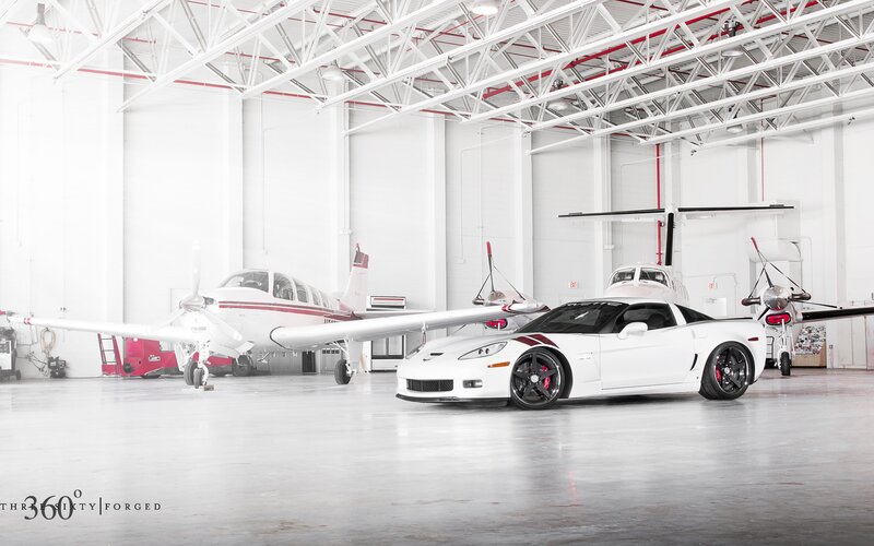 White Corvette in Hangar — Serene