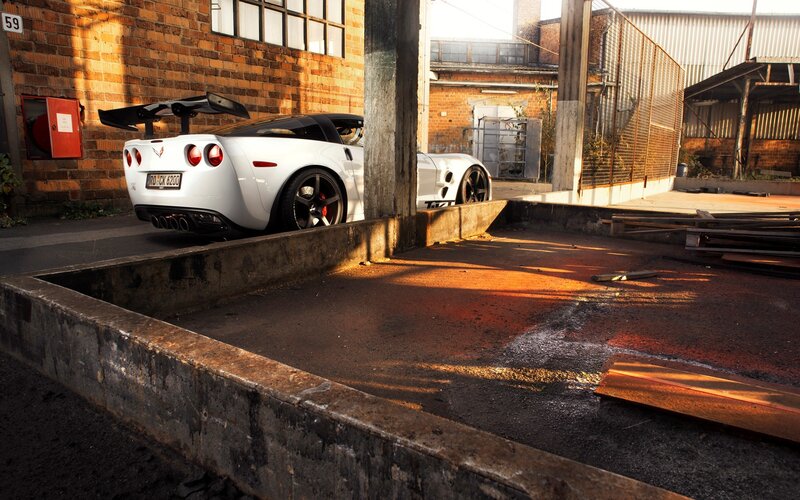 White Corvette in industrial lot