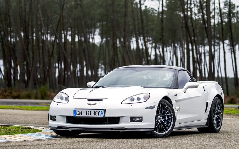 White Corvette on a racetrack