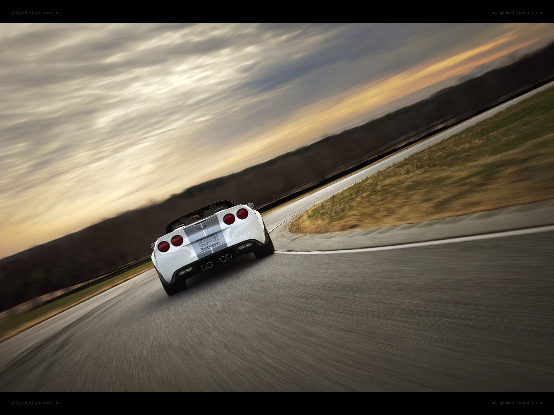 White Corvette on a racetrack
