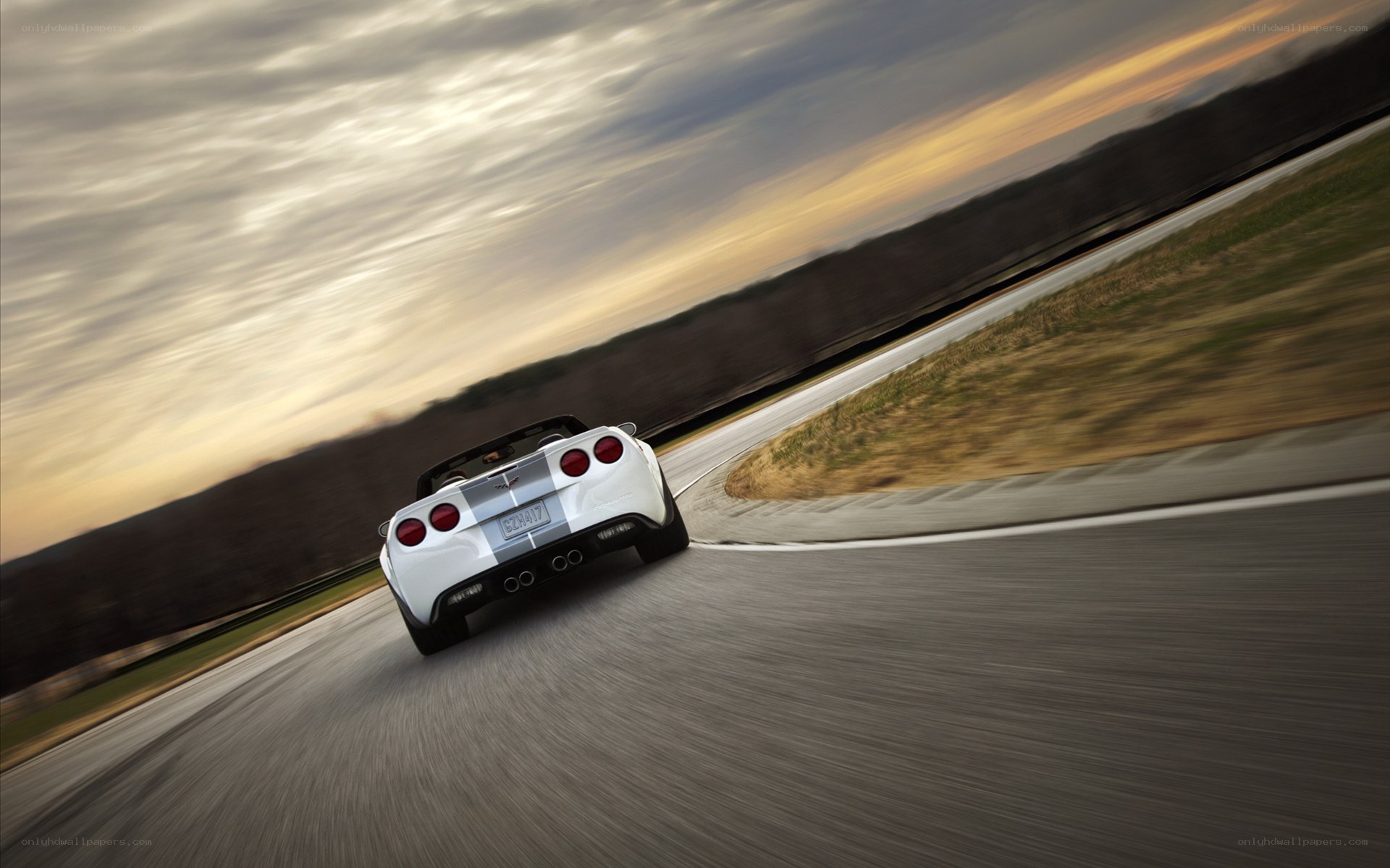 white corvette on a racetrack