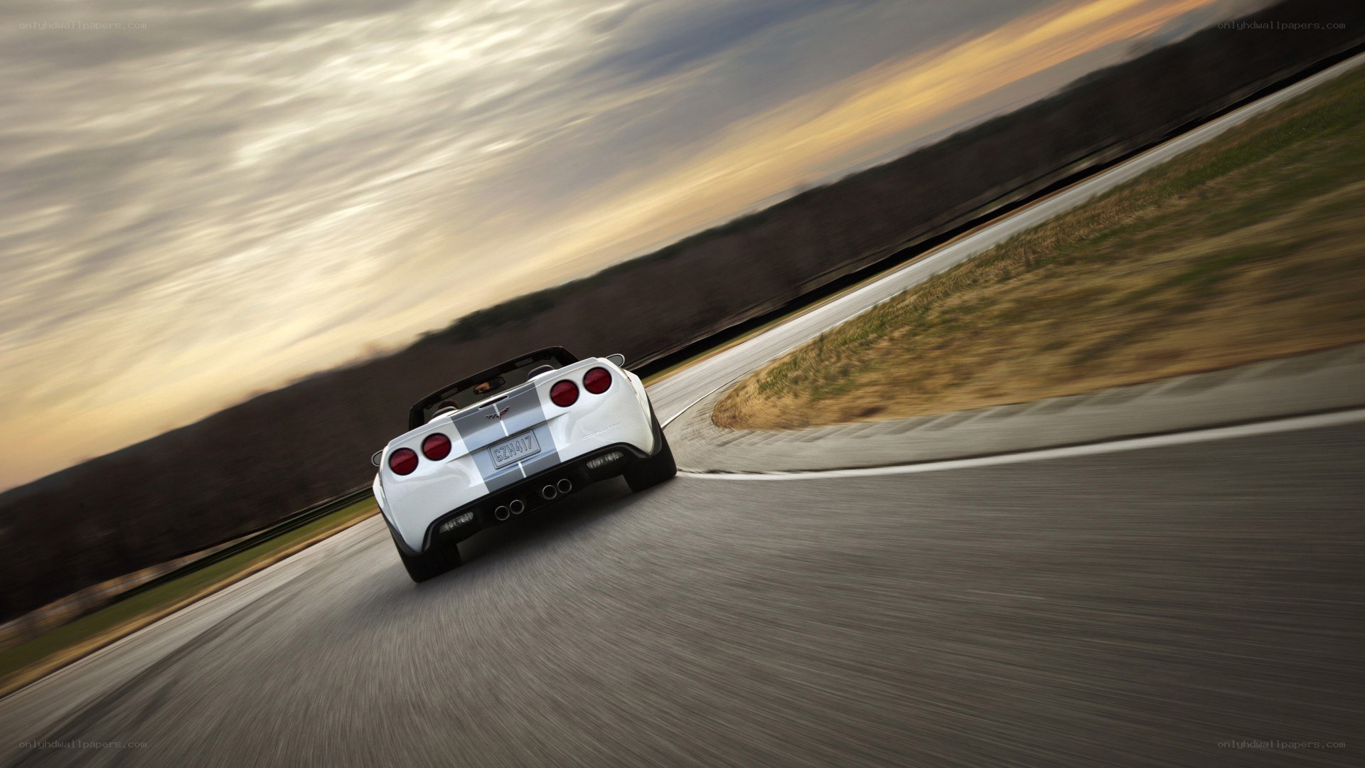 White Corvette on a winding road