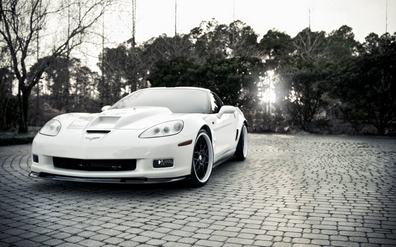 white corvette on cobblestones